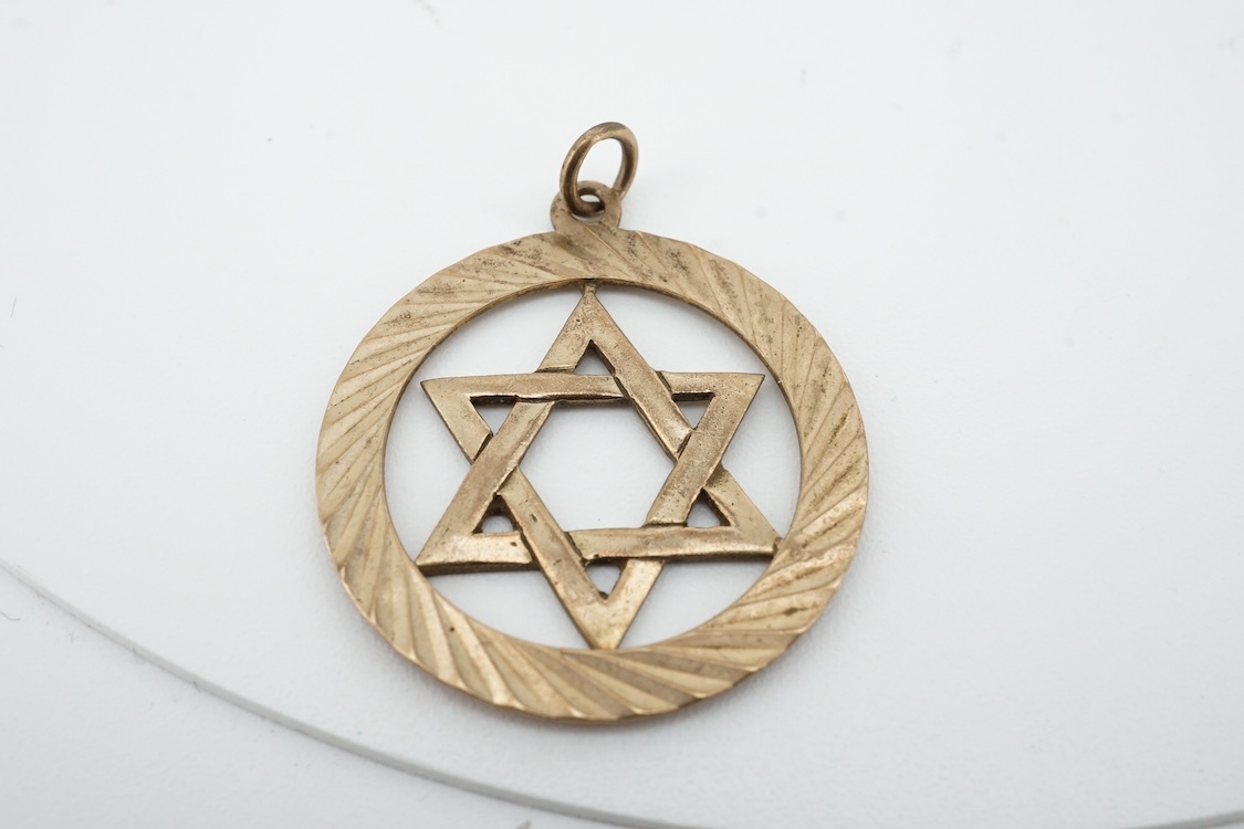 A modern 9ct gold Star of David pendant, diameter 22mm, a 9ct gold St Christopher's pendant on a 9ct chain and an Italian Uno-A-Erre 9k Mercedes insignia keyring, gross weight 22.2 grams.